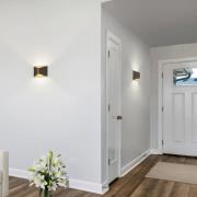 Helestra LED-vägglampa VID, svart/guld, upp/ner, IP65